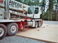 truck loading onto drilling containment pad