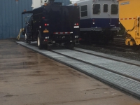 Truck on heavy duty galvanized steel track pans for Polystar Containment Star Track Spill Containment System