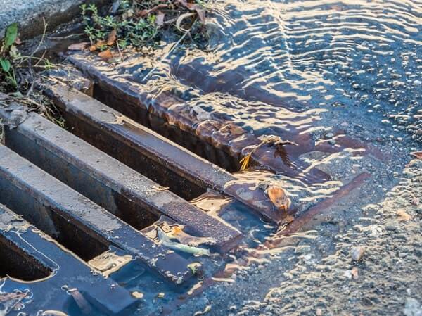 Contaminated water flows into a storm drain without a 